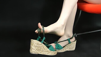 Close-Up Of Asian Feet In Stylish Wedge Sandals